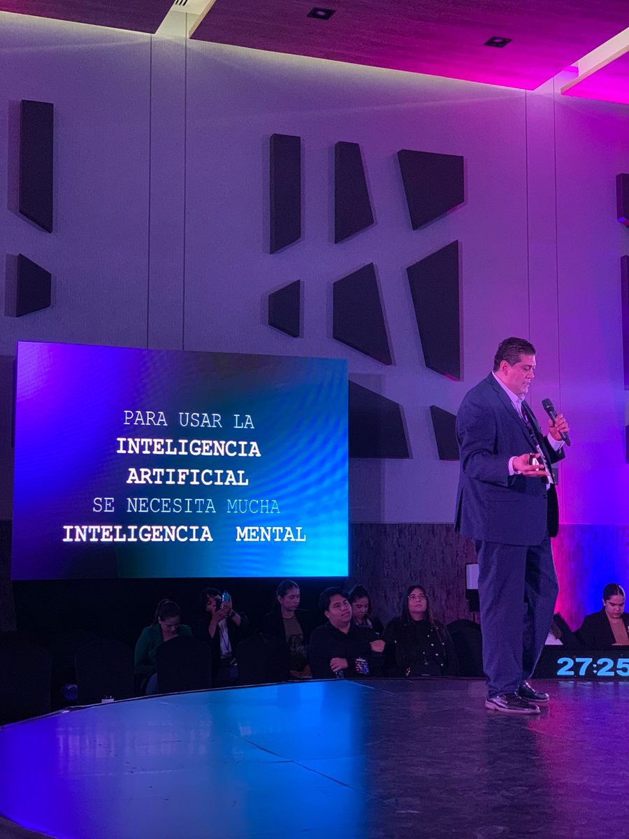 Michel Martínez frente a una pantalla que dice: Para usar la inteligencia artificial se necesita mucha inteligencia mental